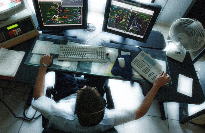 a person at a computer with several screens